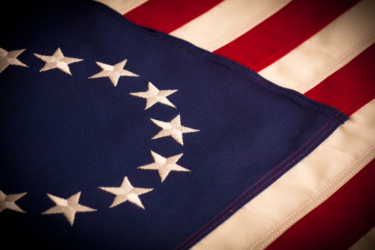 A thumbnail image of a folded American flag with thirteen stars.